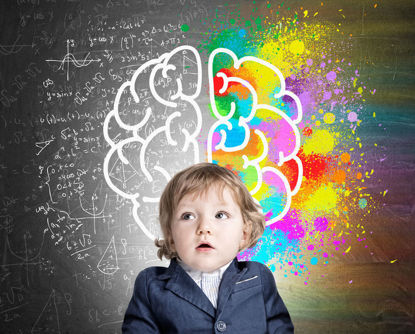 child sitting in front of a drawing of a brain