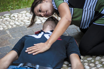 woman assisting a male on the ground 